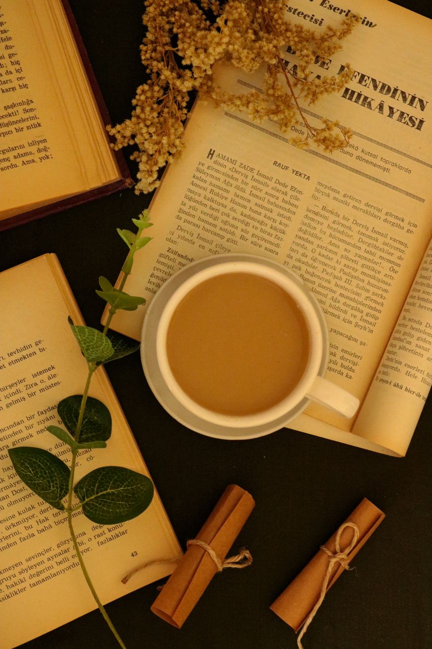 overhead shot of a cup of coffee on top of a book